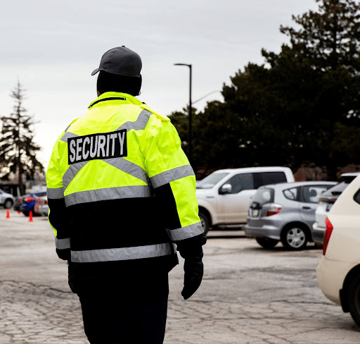 A man wearing a security jacket stands confidently, ready to ensure safety and security in his environment.